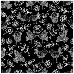 Seamless floral pattern with silhouettes birds on branches 