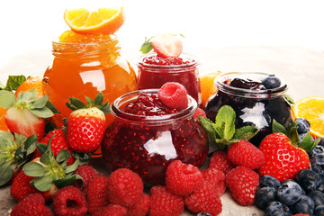 assortment of jams, seasonal berries jelly, mint and fruits and tangerine