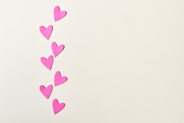 Greeting card with hearts for Valentine's Day. A lot of pink hearts on a light background. 