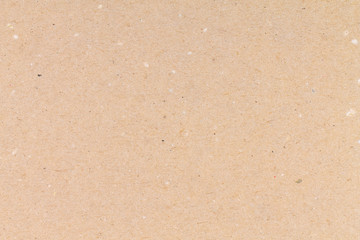 Beige paper background with spotty texture. Craft paper.