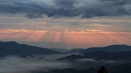 mountain landscape with colorful vivid sunset on the cloudy sky