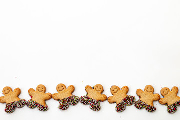 Symbol of Merry Christmas and Happy New Year:  set of smiling gingerbread man. Sweet holiday cookies isolated on white background
