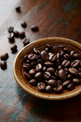 Coffee beans on rustic wooden background. Close up. 