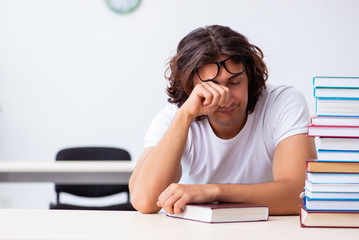 Young male student sitting in the classroom