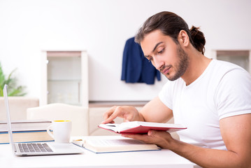 Obraz premium Young male student preparing for exams at home