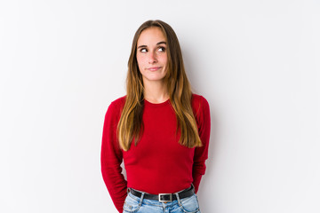 Young caucasian woman posing isolated  confused, feels doubtful and unsure.