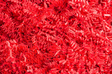 Red Paper Strips Filling From A Package Box