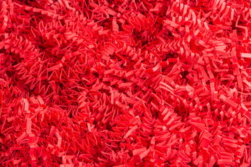 Fototapeta premium Red Paper Strips Filling From A Package Box