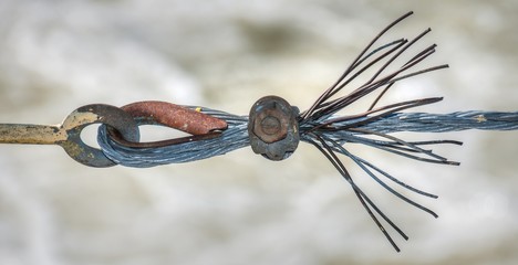 frayed steel cable wire from a guard rail