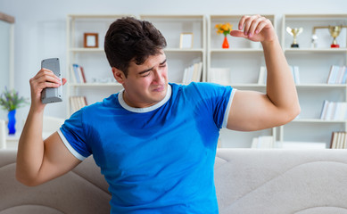 Man sweating excessively smelling bad at home