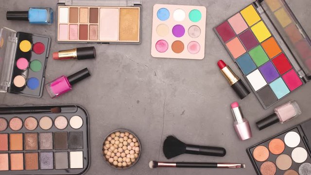 Make up and cosmetics set for woman appear on grey background - Stop motion 