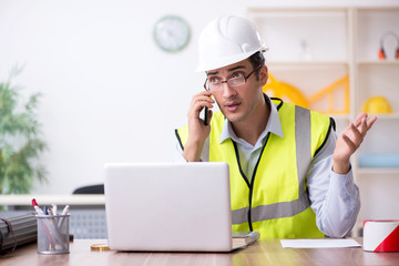 Young male architect working in the office