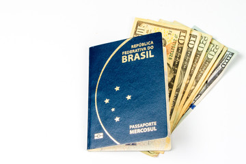New brazilian passport, with some of dollar bills, in a white back ground. its good use for travel agency. 