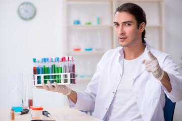 Young male chemist working in the lab