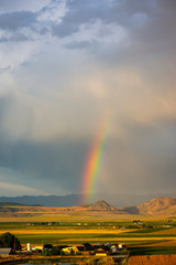 Rainbow near Tremonton Utah with farmland view