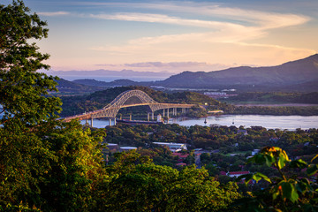 Container ship passing through Panama canal in scenic landscape - obrazy, fototapety, plakaty