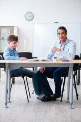 Young father helping his son to prepare for exam