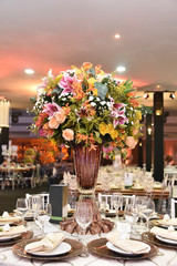 A luxurious bouquet of fresh flowers in a crystal vase on the holiday table and an elegant portion in the restaurant.