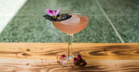 Orange cocktail with a purple flower