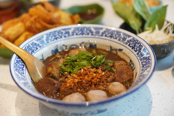 Thai meat noodles in white bowl