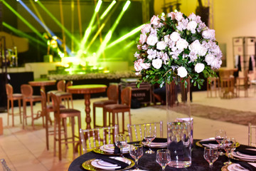 A luxurious bouquet of fresh flowers in a crystal vase on the holiday table and an elegant portion in the restaurant.