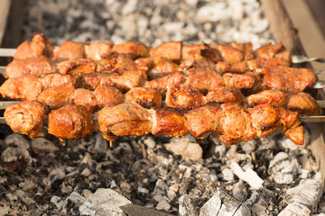 Meat slices prepare on fire. Baked meat on skewers.