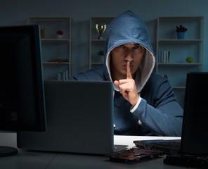 Hacker hacking computer at night