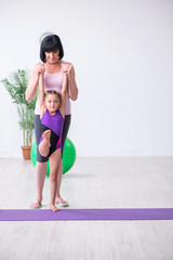 Girl and mother exercising at home