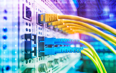 Fiber Optic cables connected to an optic ports and Network cables connected to ethernet ports