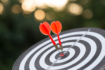 Red dart target arrow hitting on bullseye with,Target marketing and business success concept