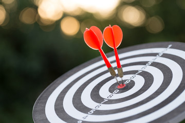 Fototapeta na wymiar Red dart target arrow hitting on bullseye with,Target marketing and business success concept