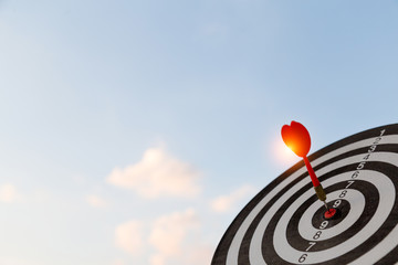 Red dart target arrow hitting on bullseye with,Target marketing and business success concept