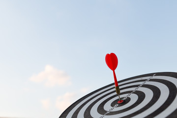 Red dart target arrow hitting on bullseye with,Target marketing and business success concept