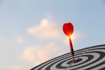 Red dart target arrow hitting on bullseye with,Target marketing and business success concept