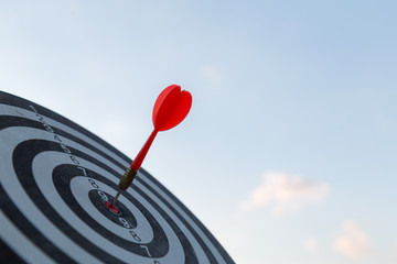 Red dart target arrow hitting on bullseye with,Target marketing and business success concept