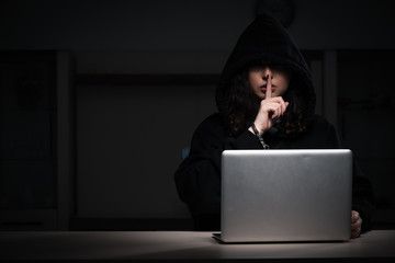 Female hacker hacking security firewall late in office