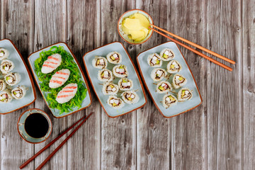 Chinese cuisine. Set of sushi roll with soy sauce, ginger and chopstick.