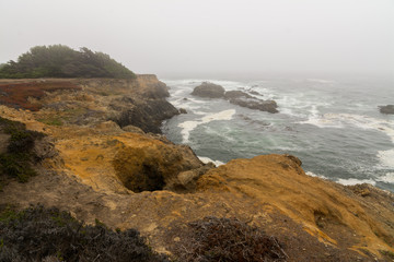 Fototapeta na wymiar Ocean cliff coastal landscape storm and fog .