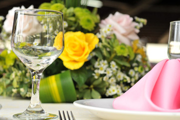 Table setting with glasses, plates, napkins and food