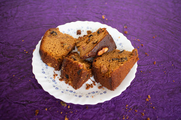 Plum cake made with dried fruit, raisins, cashew nuts, almond etc. Tasty home made cake flavored with cinnamon and spices for sale on Indian Christmas and new year Kerala India.