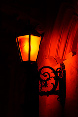 Fototapeta na wymiar Old street lantern on a wall at night