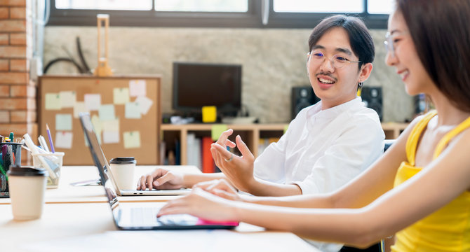 asian businessman and woman discussing with good communication together in office couple officer flirting together with joyful