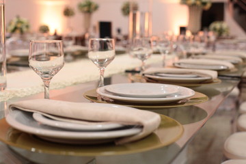 Table setting with glasses, plates, napkins and food