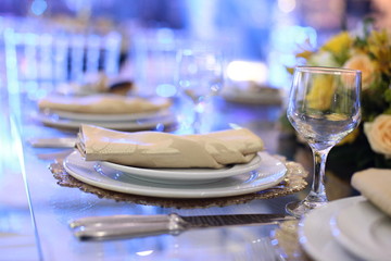 Table setting with glasses, plates, napkins and food