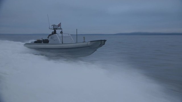 Norwegian army military gunship speed boat passing