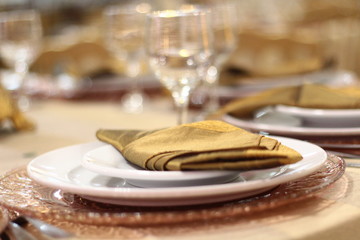 Table setting with glasses, plates, napkins and food
