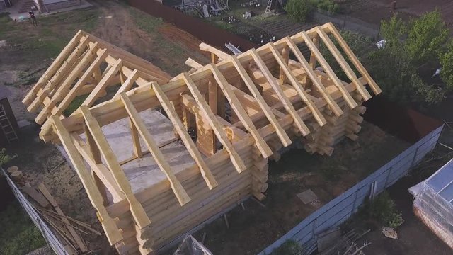 Project of the home from wooden bars, remodeling of the cottage. Clip. Aerial of the house wooden foundation in the village.