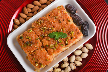 Arabic sweet Basbousa, Hareeseh, almonds and pistachios  festival dessert Dubai, UAE.