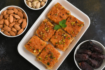 Arabic sweet Basbousa, Hareeseh, almonds and pistachios  festival dessert Dubai, UAE.