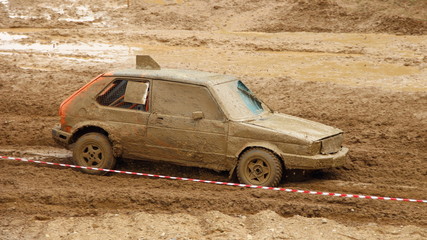 Old European classic front wheel drive dirty racing car hatchback on off road race, auto cross...